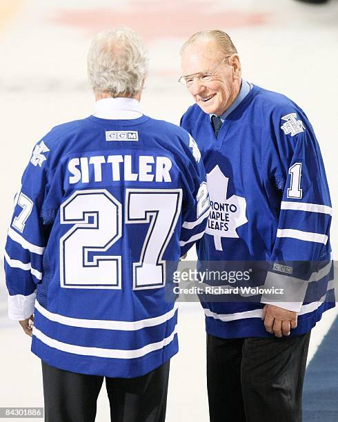 Former Toronto Maple Leafs goalie Johnny Bower greets Darryl Sittler during pre-game ceremonies before the game between the Toronto Maple Leafs and...