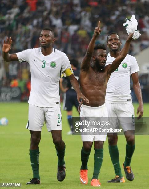 Saudi Arabia's players celebrate after winning the FIFA World Cup 2018 qualification football match between Saudi Arabia and Japan at King Abdullah...