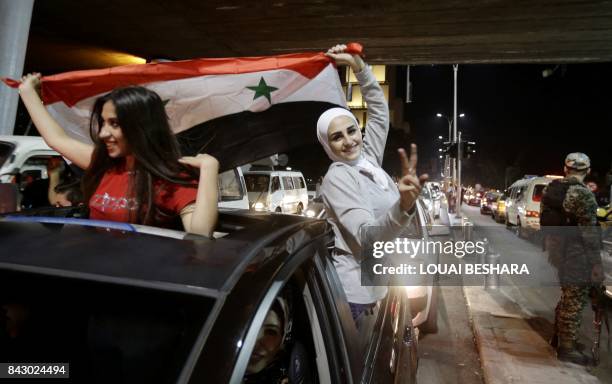 Syrian football fans celebrate in the streets of Damascus after the FIFA World Cup 2018 qualification football match between Iran and Syria ended in...