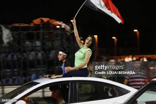 Syrian football fans celebrate in the streets of Damascus after the FIFA World Cup 2018 qualification football match between Iran and Syria ended in...