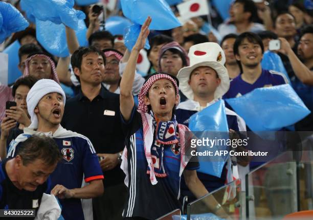 Japan's fans cheer during the FIFA World Cup 2018 qualification football match between Saudi Arabia and Japan at King Abdullah bin Abdulaziz Stadium...