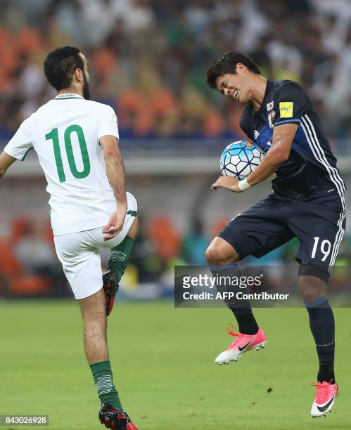 Saudi Arabia's Mohammed Alsahlawi and Japan's Hiroki Sakai fight for the ball during the FIFA World Cup 2018 qualification football match between...