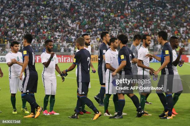 Saudi Arabia's playes great Japan's team players during the FIFA World Cup 2018 qualification football match between Saudi Arabia and Japan at King...