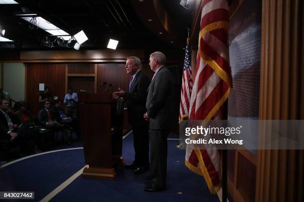 Senate Minority Leader Richard Durbin speaks as Sen. Lindsey Graham listens during a news conference at the Capitol September 5, 2017 in Washington,...