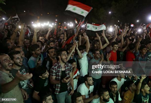 Syrian football fans watch in Damascus the FIFA World Cup 2018 qualification football match between Iran and Syria, played in Iran, on September 5,...