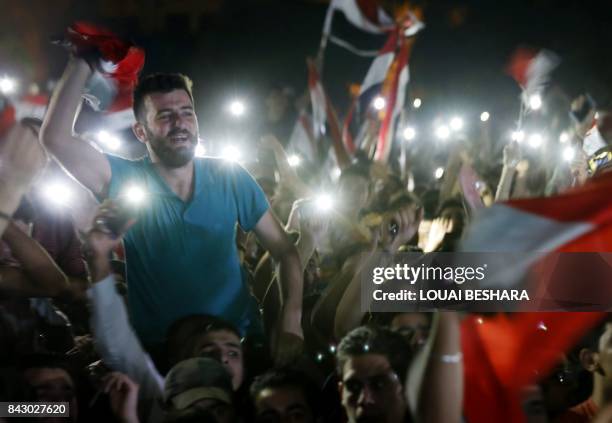 Syrian football fans watch in Damascus the FIFA World Cup 2018 qualification football match between Iran and Syria, played in Iran, on September 5,...