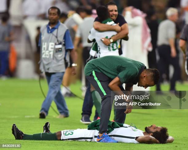 Saudi Arabia's players celebrate after winning the FIFA World Cup 2018 qualification football match between Saudi Arabia and Japan at King Abdullah...