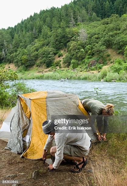 couple preparing campsite - rogue river stock pictures, royalty-free photos & images