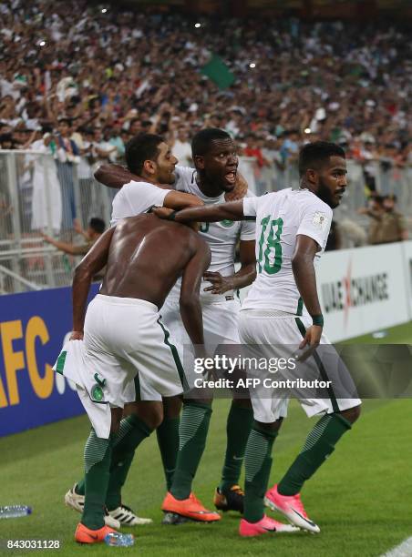 Saudi Arabia's players celebrate after winning the FIFA World Cup 2018 qualification football match between Saudi Arabia and Japan at King Abdullah...