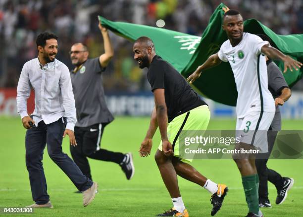 Saudi Arabia's players celebrate after winning the FIFA World Cup 2018 qualification football match between Saudi Arabia and Japan at King Abdullah...