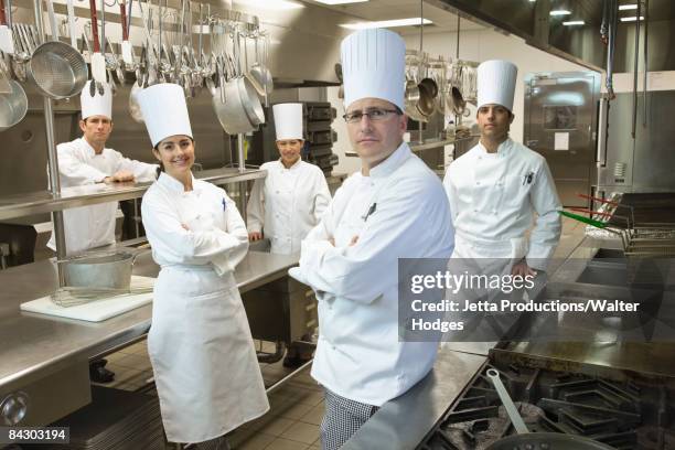 chefs posing in kitchen - traditionele koksmuts stockfoto's en -beelden