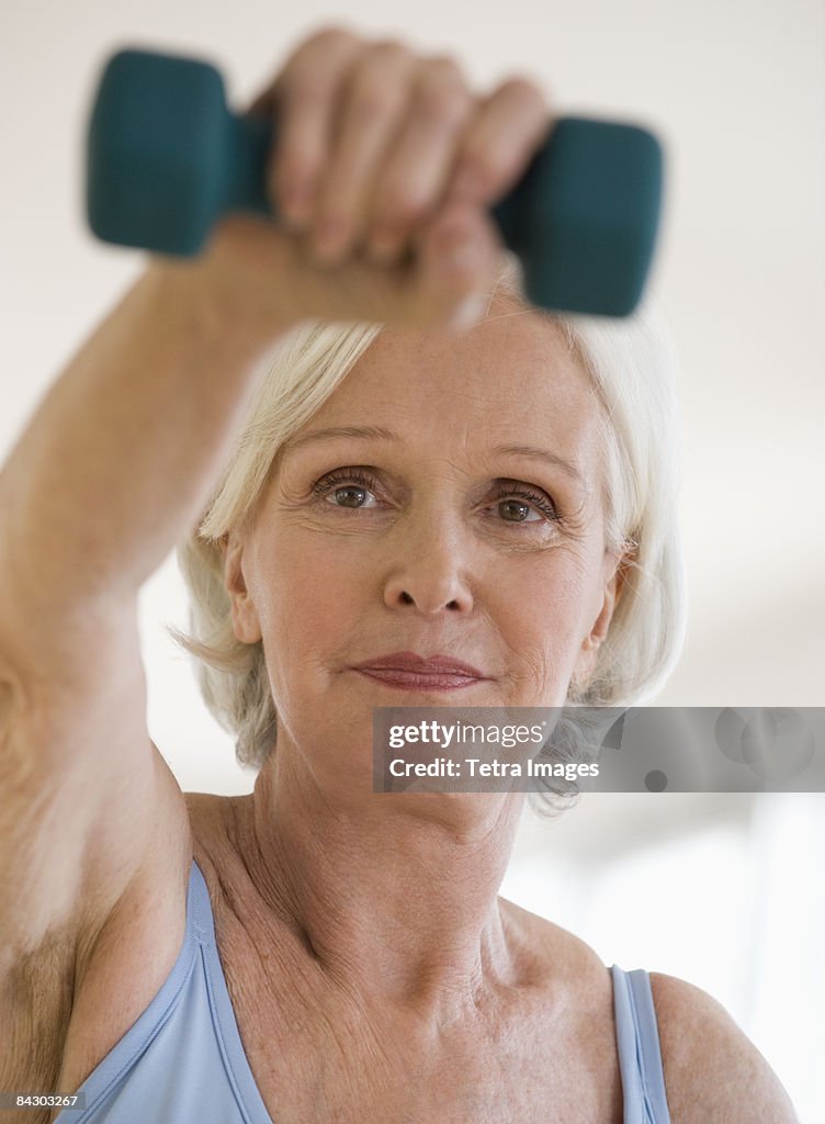 Senior woman lifting hand weight