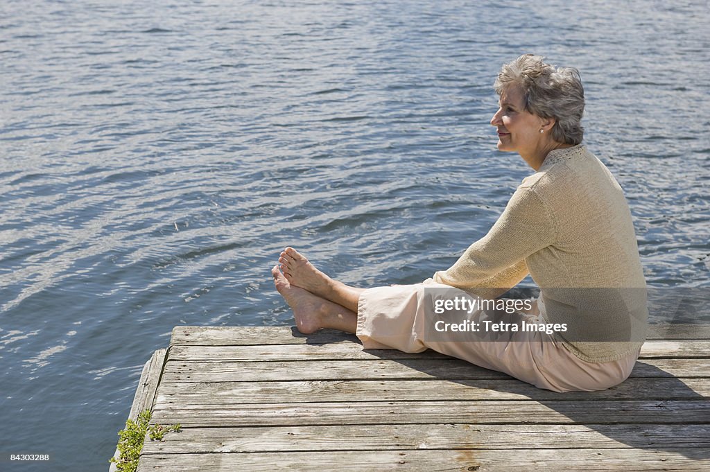 Senior woman sitting on dock