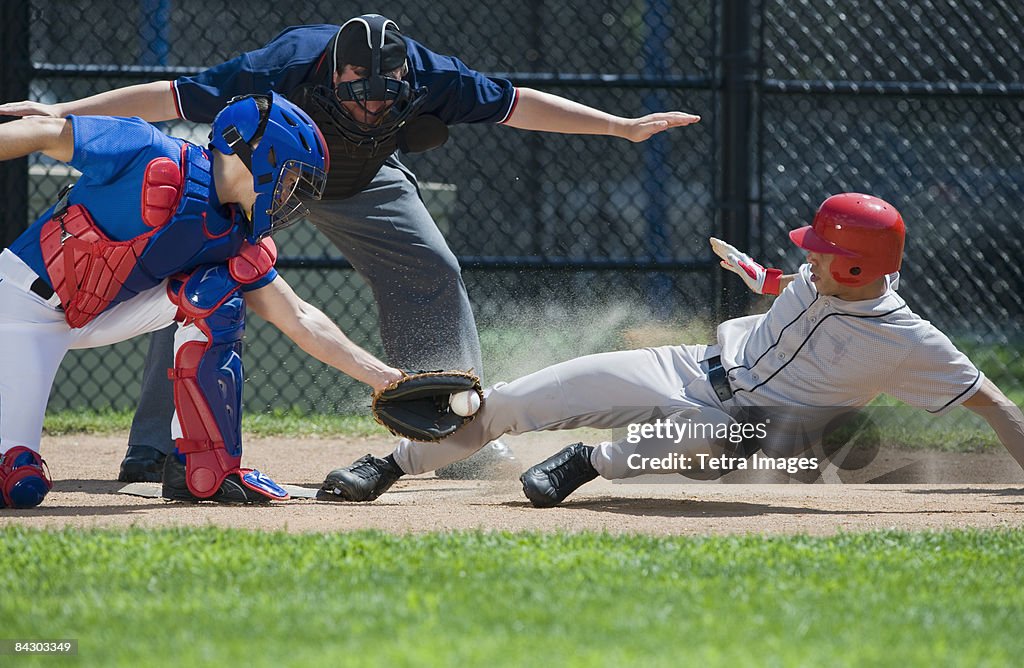 Baseball player sliding into home plate