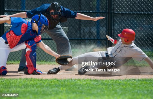 Baseball player sliding into home plate Baseball player sliding into home plate