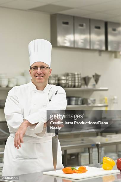 chef posing in kitchen - toque stock pictures, royalty-free photos & images