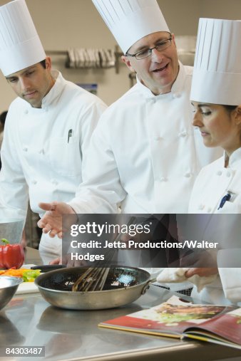 Head chef teaching cooking techniques Head chef teaching cooking techniques