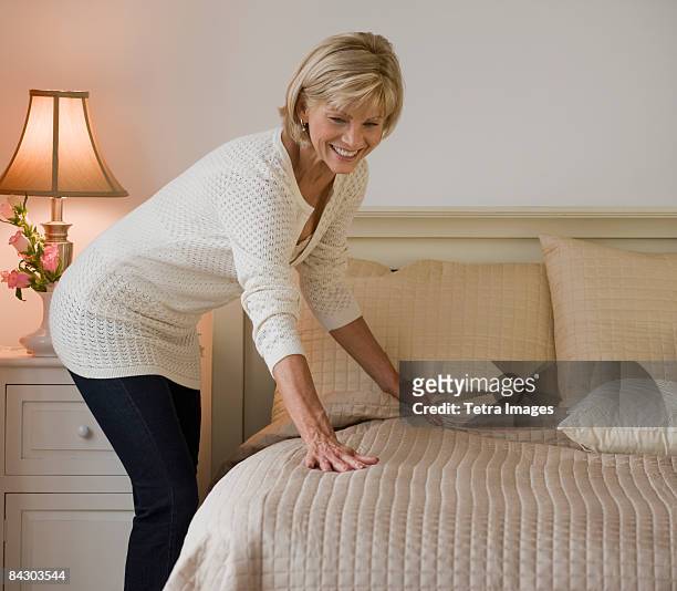 woman making bed - woman make up stock pictures, royalty-free photos & images