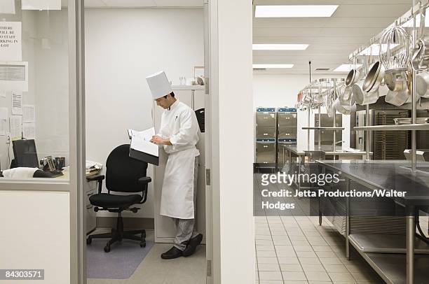 head chef standing in kitchen office - chef full length stock pictures, royalty-free photos & images