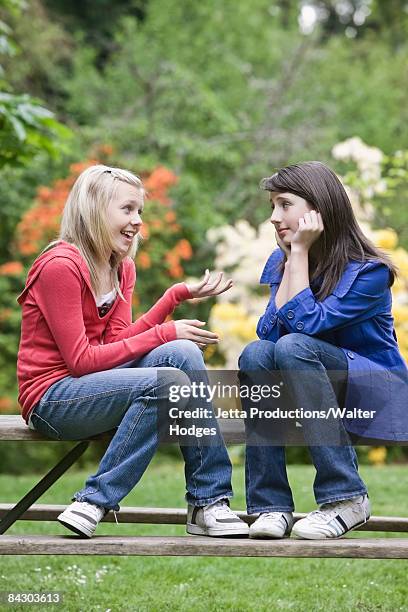 girls talking in park - only girls stock pictures, royalty-free photos & images