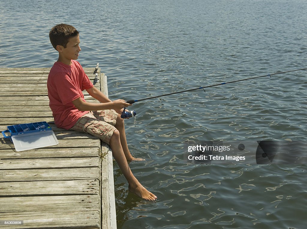 Boy fishing off dock