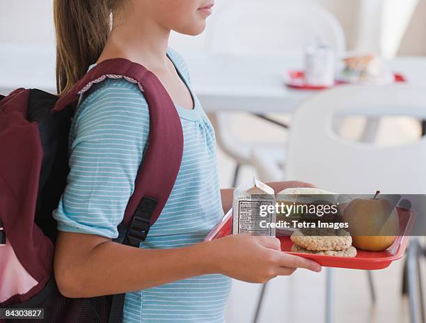 girl carrying lunch tray at school - cafeteria foto e immagini stock