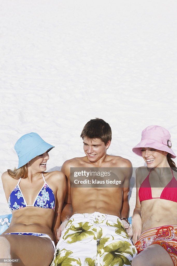 Friends Sunbathing On Beach High Res Stock Photo Getty Images friends-sunbathing-on-beach-high-res-stock-photo-getty-images