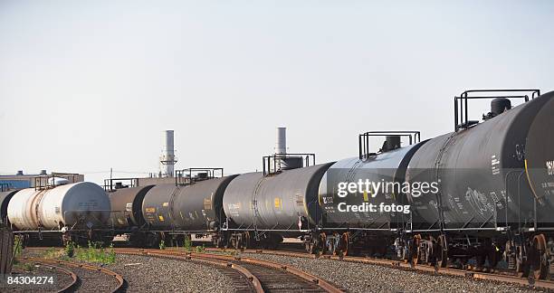 row of oil tankers in train track - vorratstank stock-fotos und bilder