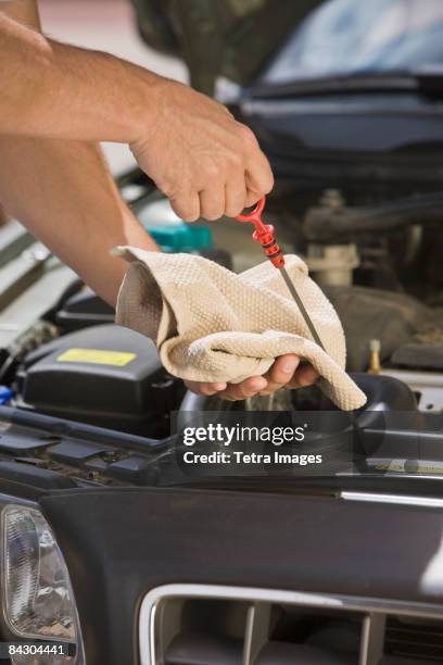 mechanic checking oil - dipstick stock pictures, royalty-free photos & images