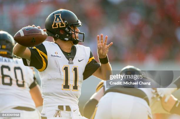 Quarterback Taylor Lamb of the Appalachian State Mountaineers looks to throw the ball during their game against the Georgia Bulldogs at Sanford...