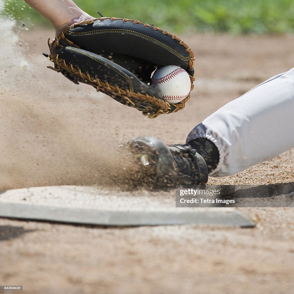 Close up of baseball player sliding into home plate