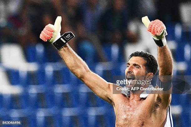 Italy's goalkeeper and captain Gianluigi Buffon waves to supporters at the end of the FIFA World Cup 2018 qualification football match between Italy...