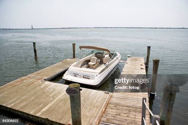 boat moored at dock - speedboat stock pictures, royalty-free photos & images