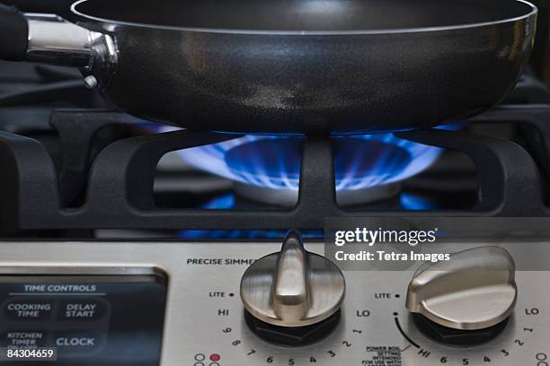 close up of skillet on gas stove - cooker dial stock pictures, royalty-free photos & images