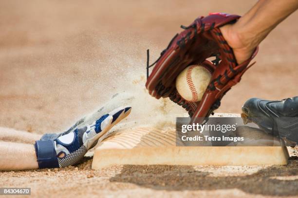 baseball player sliding into home base - baseball base stock pictures, royalty-free photos & images