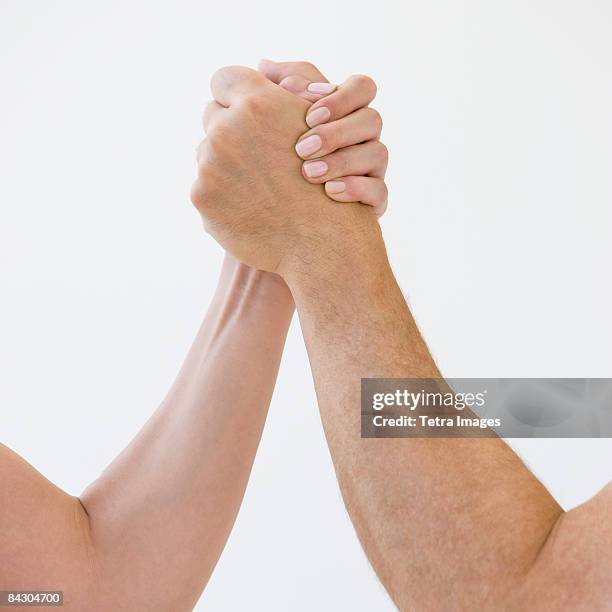 couple arm wrestling - rough housing stock-fotos und bilder