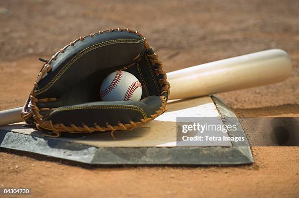 baseball equipment on home plate - baseball glove stock pictures, royalty-free photos & images