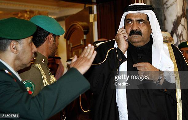 Saudi army officer salutes Qatar's Emir Sheikh Hamad bin Khalifa al-Thani as he arrives to attend an emergency summit meeting of the Gulf Cooperation...