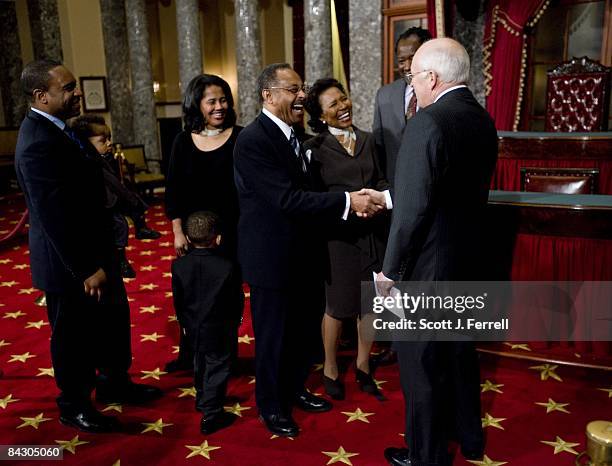 Newly sworn in Sen. Roland W. Burris, D-Ill., shaking hands with Vice President Dick Cheney, wife Berlean M. Burris and family during a mock swearing...