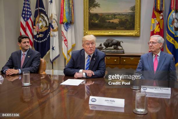 President Donald Trump , with Speaker of the House Paul Ryan and Senate Majority Leader Mitch McConnell , delivers remarks during a meeting with...