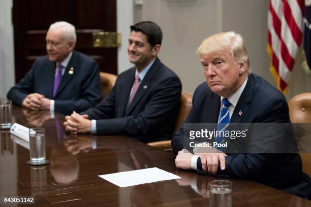 President Donald Trump with Speaker of the House Paul Ryan , Chairman of the Senate Finance Committee Orrin Hatch and other members of congress and...