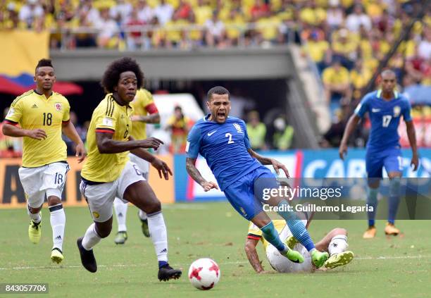 Edwin Cardona of Colombia drives the ball as Dani Alves of Brazil falls after a foul during a match between Colombia and Brazil as part of FIFA 2018...