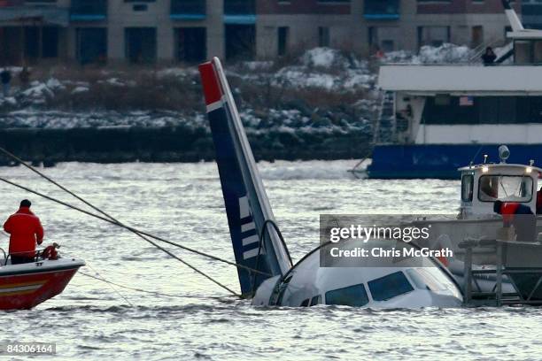 Rescue crews secure a US Airways flight 1549 floating in the water after it crashed into the Hudson River January 15, 2009 in New York City. The...
