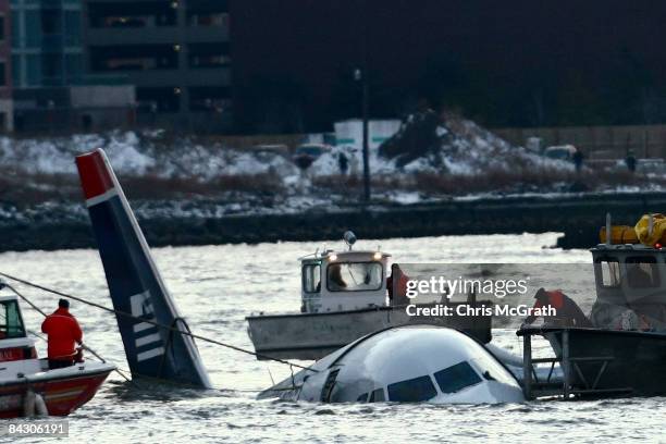 Rescue crews secure a US Airways flight 1549 floating in the water after it crashed into the Hudson River January 15, 2009 in New York City. The...