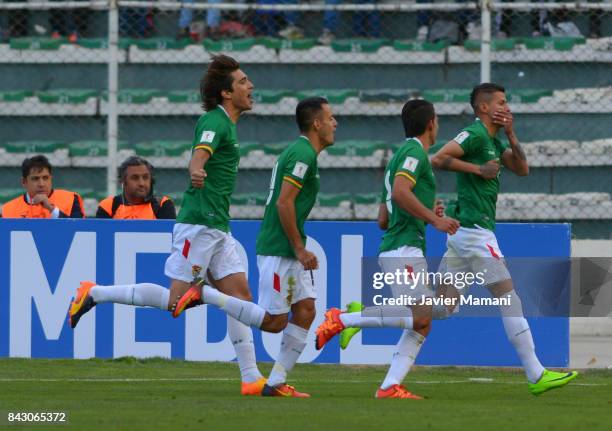 Juan Carlos Arce of Bolivia celebrates with teammates after scoring the first goal of his team during a match between Bolivia and Chile as part of...