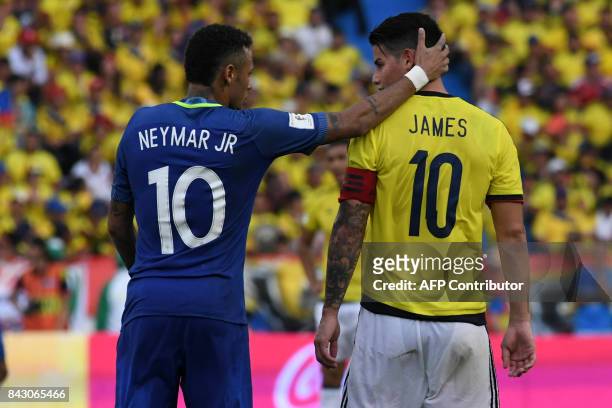 Brazil's Neymar and Colombia's James Rodriguez talk during their 2018 World Cup qualifier football match in Barranquilla, Colombia, on September 5,...