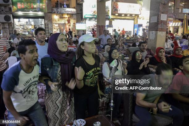 Egyptians watch the FIFA World Cup 2018 qualification football match between Egypt and Uganda at a café in Cairo's 6th of October City, west of the...