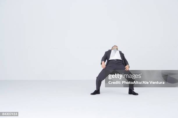 businessman doing limbo, bending backwards to go under rope - white limbo stock pictures, royalty-free photos & images