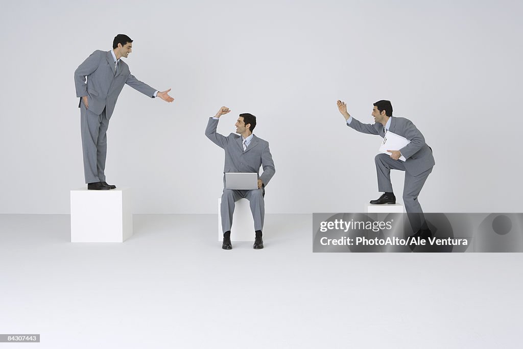 Identical businessmen congratulating each other