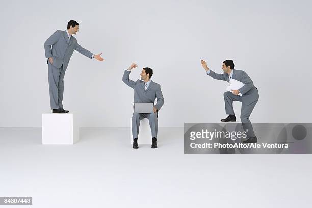 identical businessmen congratulating each other - multiple images of the same person stock pictures, royalty-free photos & images